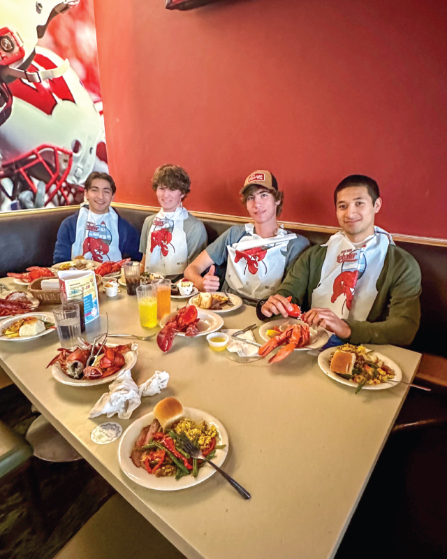 Housing Resident Appreciation Lobster Dinner - Students eating with bibs