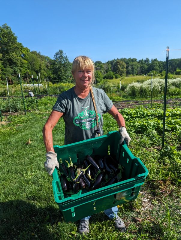 Campus Farm staff posing with produce