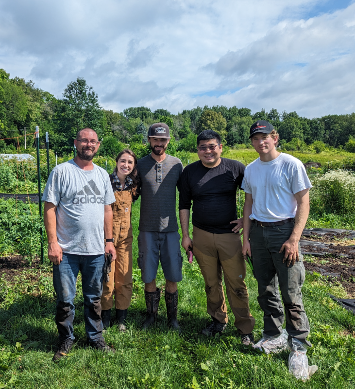 Campus Farm staff pose for photo at the farm