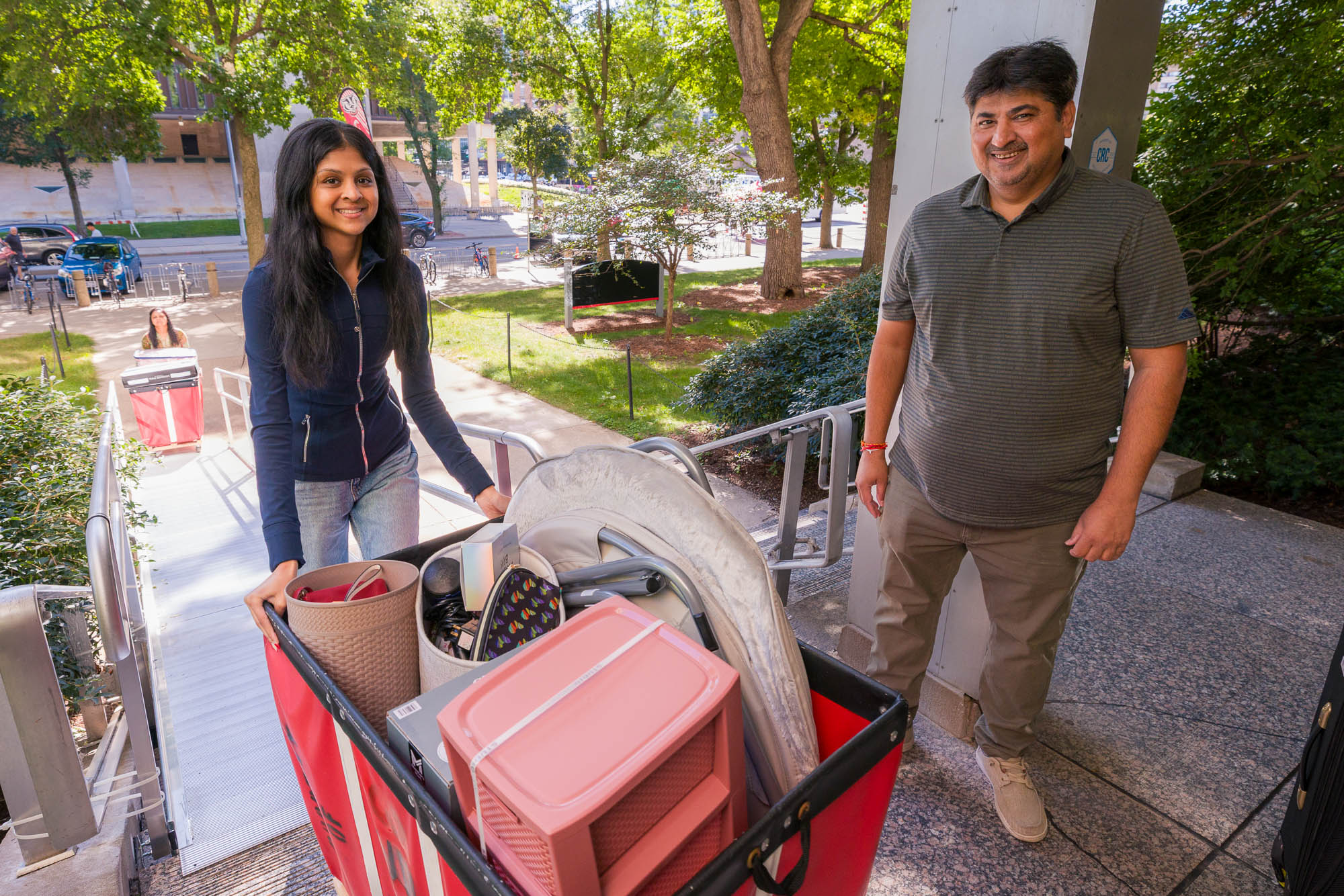 Two people with a moving cart