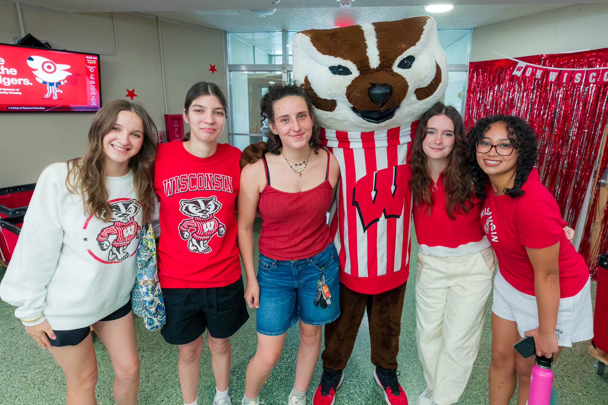 Five people pose with Bucky Badger
