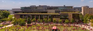 A large group of people in front of a building from a high angle