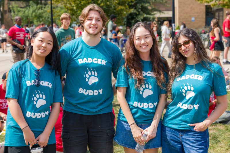 Four people smile for a photo