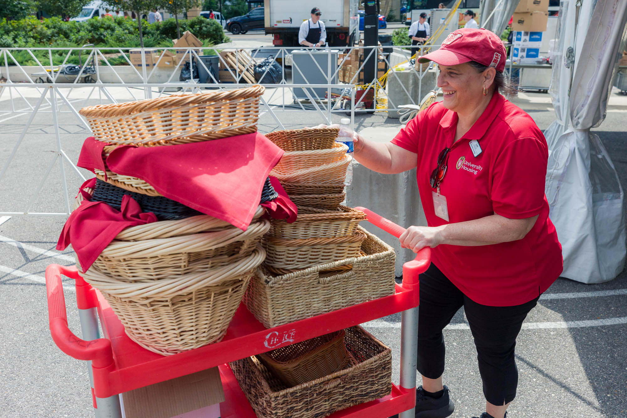 A person pushes a cart with empty baskets on it