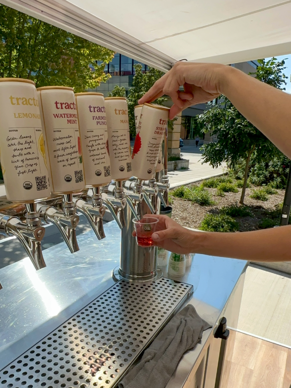 Tractor Beverage Pop Up Airstream with a staff member pouring from the tap