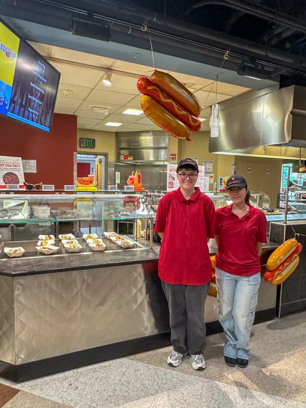Dining staff pose for National Hot Dog Day