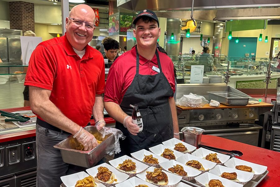 Hormel Rep and a student worker pose for a photo with the special Hormel sandwiches