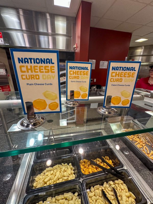 Three different types of cheese curds with signs
