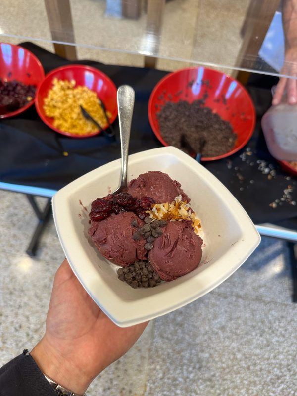 Acai bowl with toppings in the background