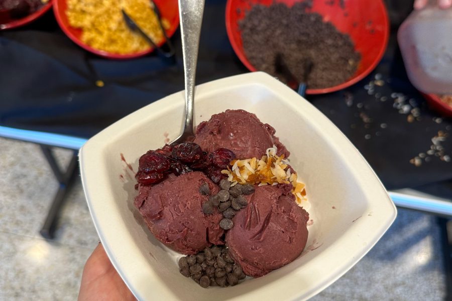 Acai bowl with toppings in the background