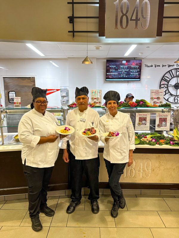 Three chefs posing with their special entree at their Chef Appreciation lunch in Gordon Avenue Market