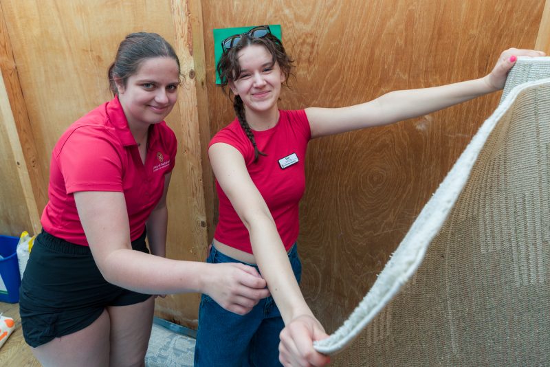 Staff members posing at Sustainability Move-Out Spring 2025 carpet collection site