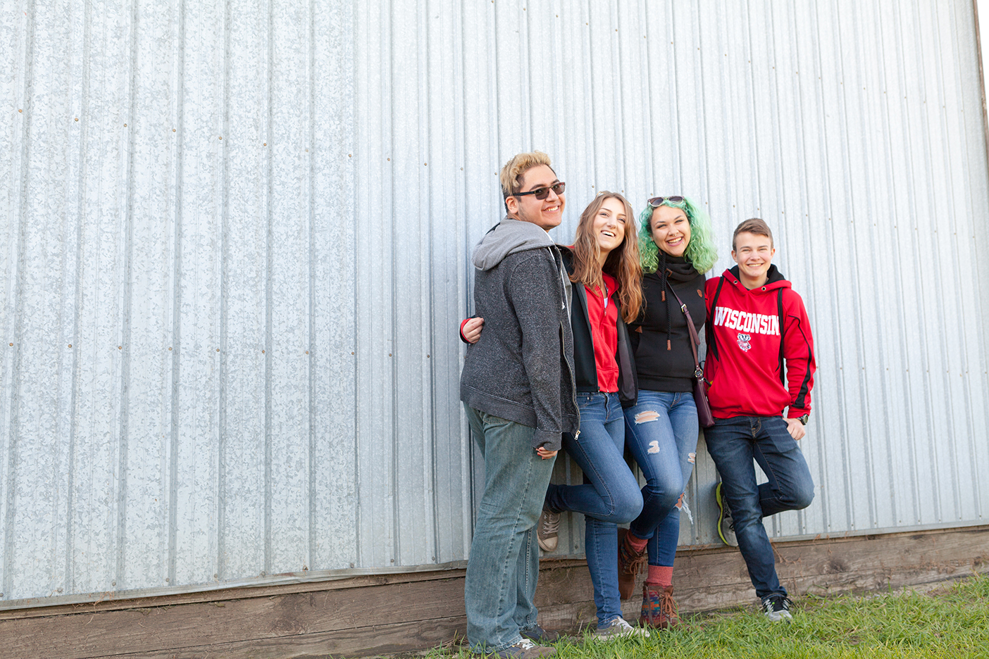 Open House residents pose outside a barn at the pumpkin farm