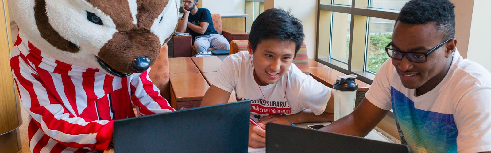 Bucky works on a computer with some other students
