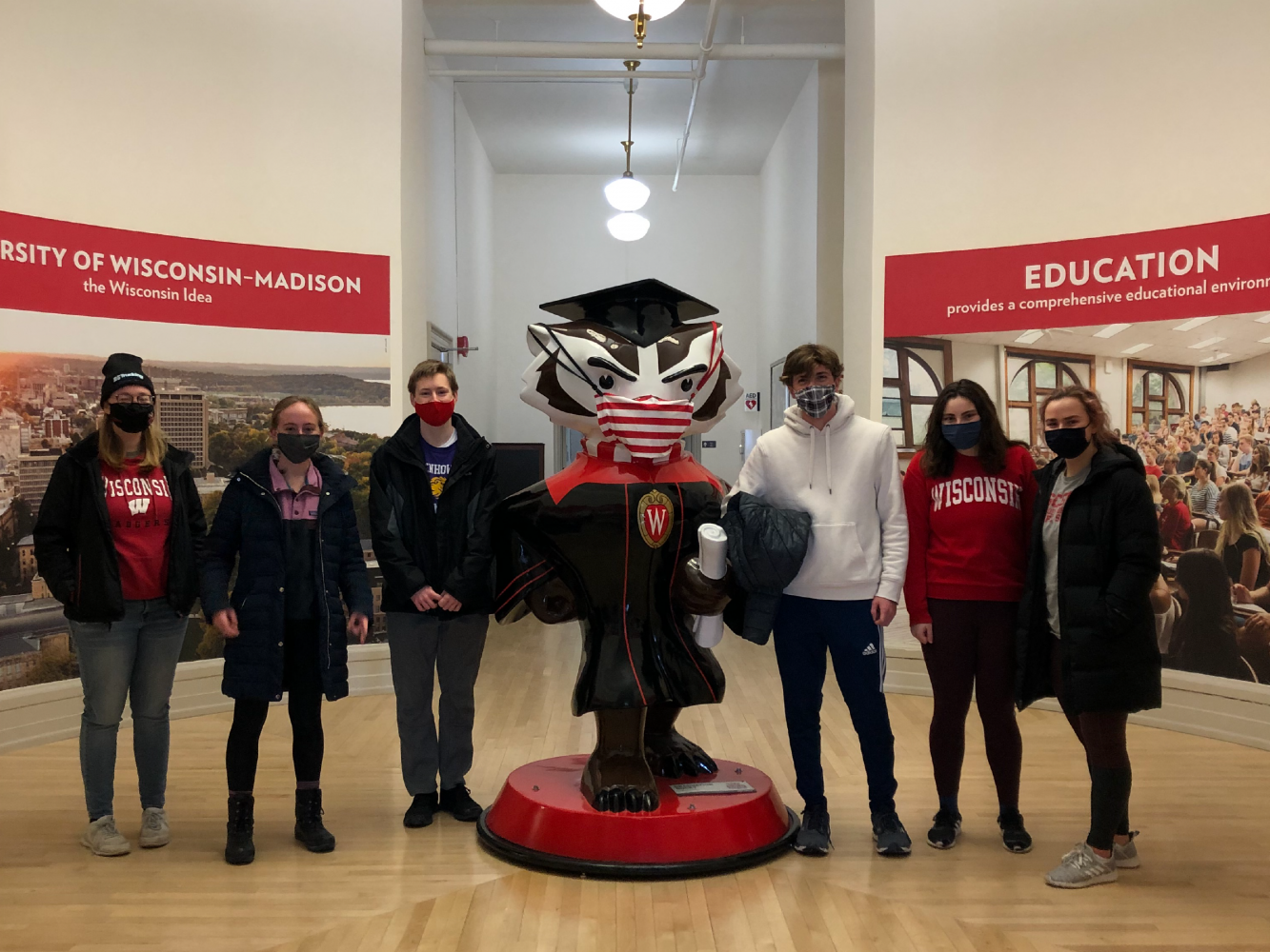 BLC residents pose with a Bucky Badger statue