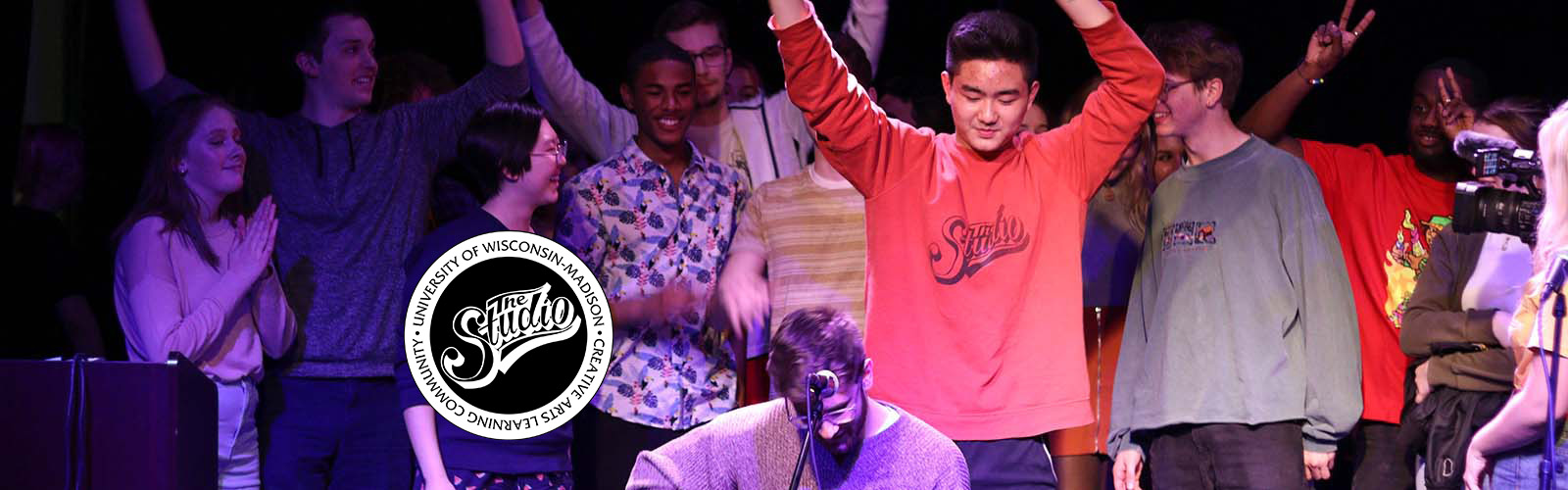 Residents in The Studio Creative Arts Learning Community look on during a guitar performance