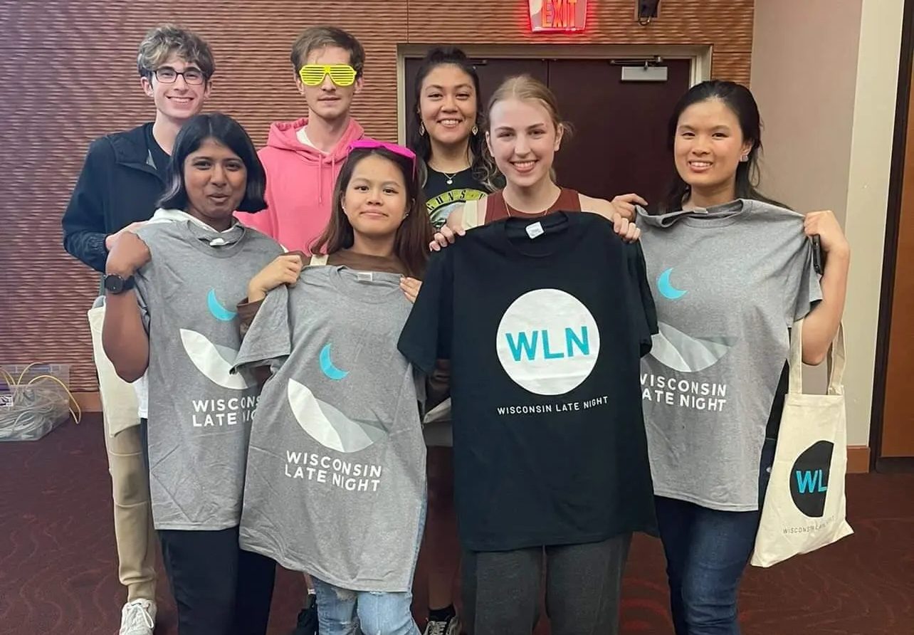 Students showing off a Wisconsin Late Night T-Shirt