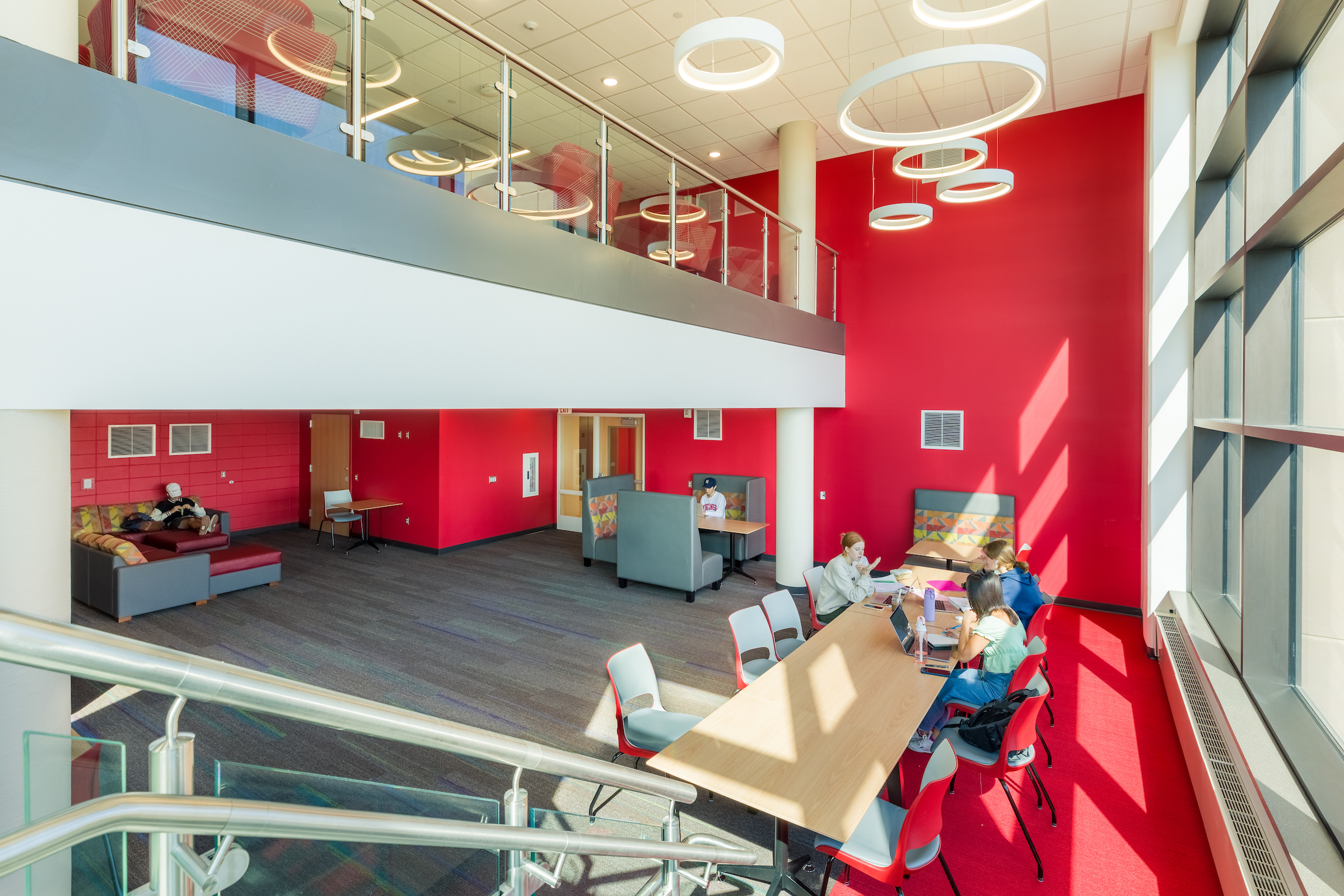 Students studying at tables in a 2-story lounge in Sellery