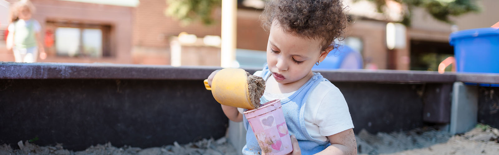 A child plays in a sandbox at Eagle's Wing