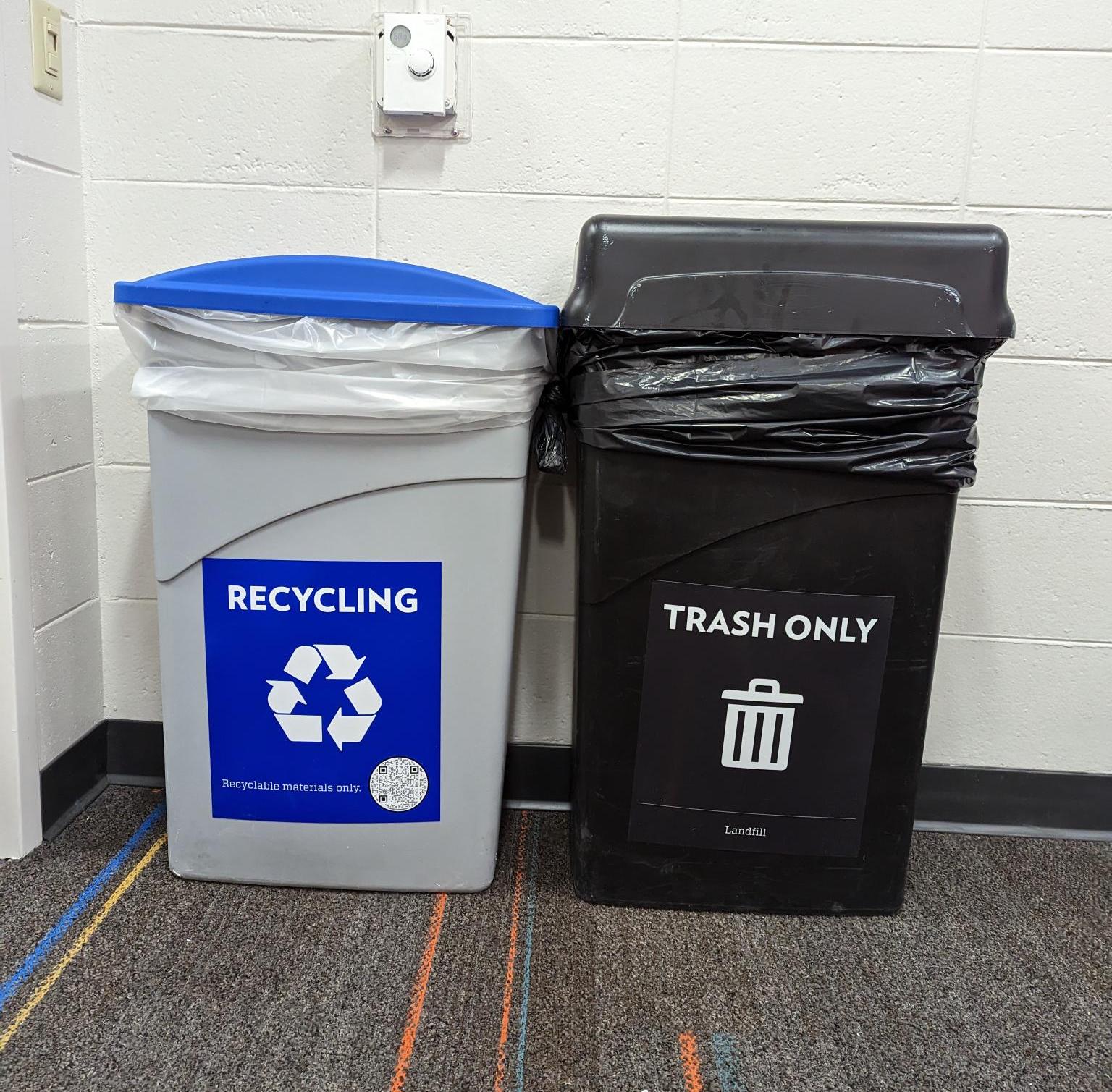 A recycling bin and a trash bin with new labels