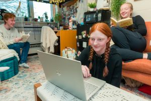 Winners of the 2023 Best Room Contest spend time with friends in their room in Cole Residence Hall