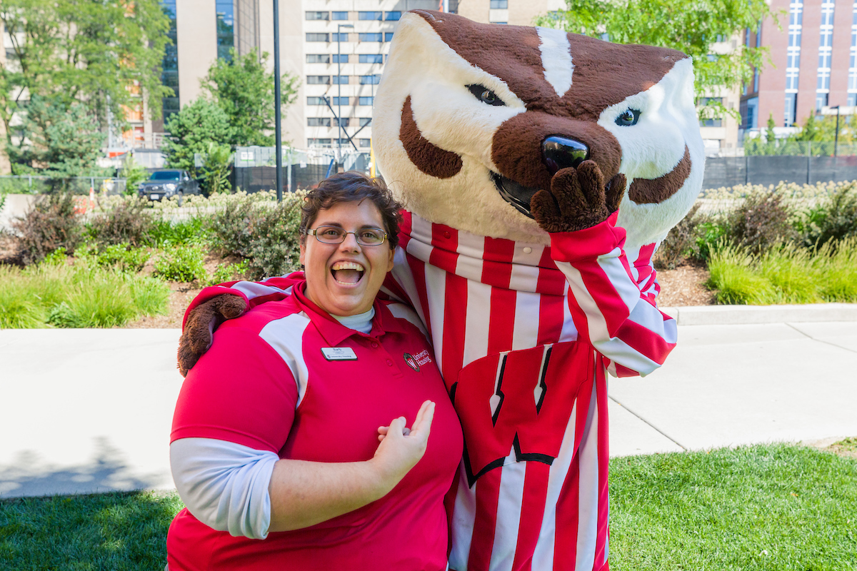 A Residence Life staff member posing for a photo with Bucky Badger