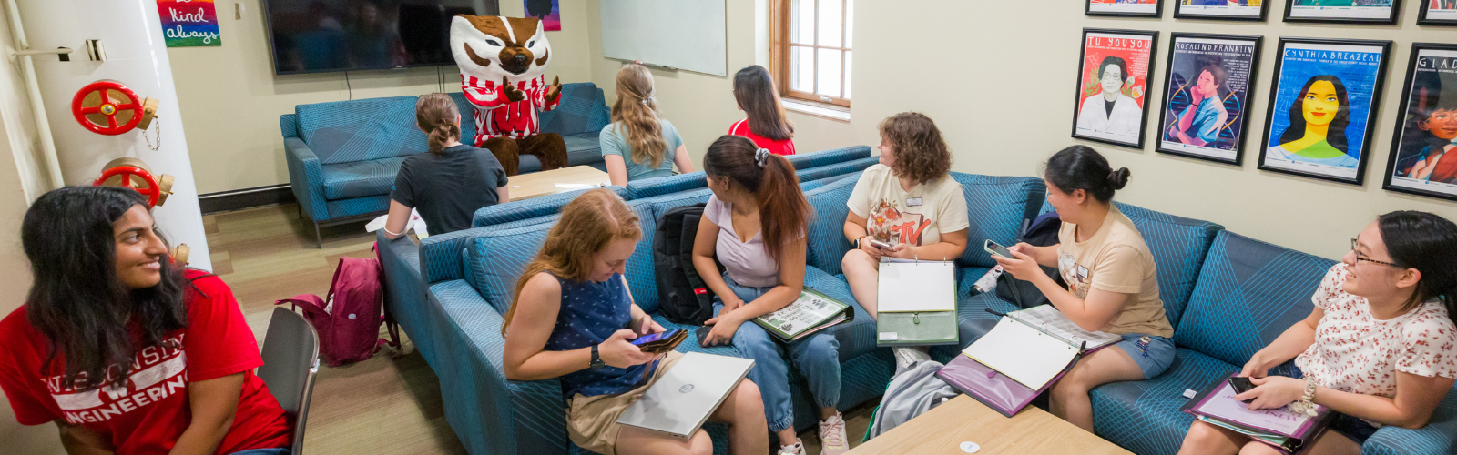 students and Bucky in lounge area