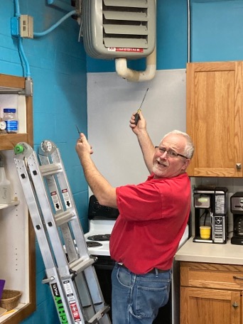 An electrician making a goofy face while on the job