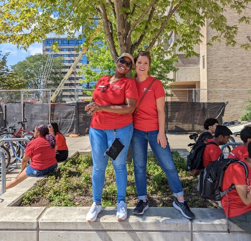 Two HR staff pose for a photo outside of Sellery Residence Hall