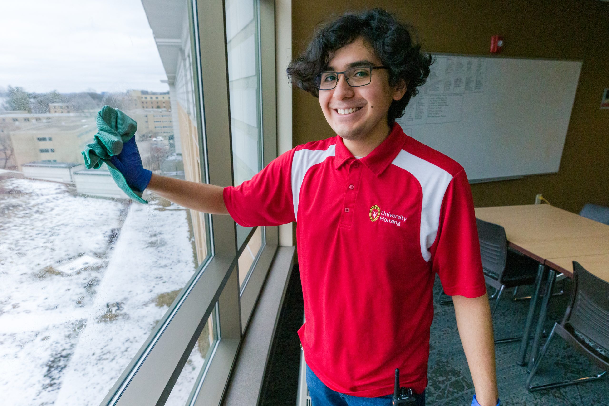 Facilities student staff wiping windows