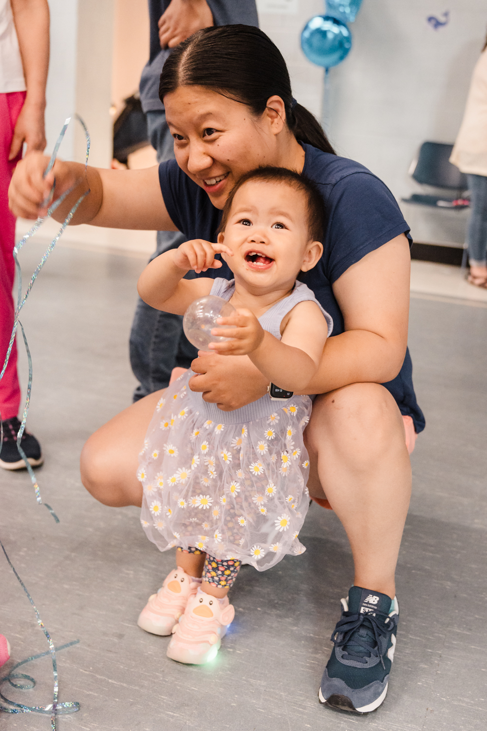An adult holding a young child enjoying music