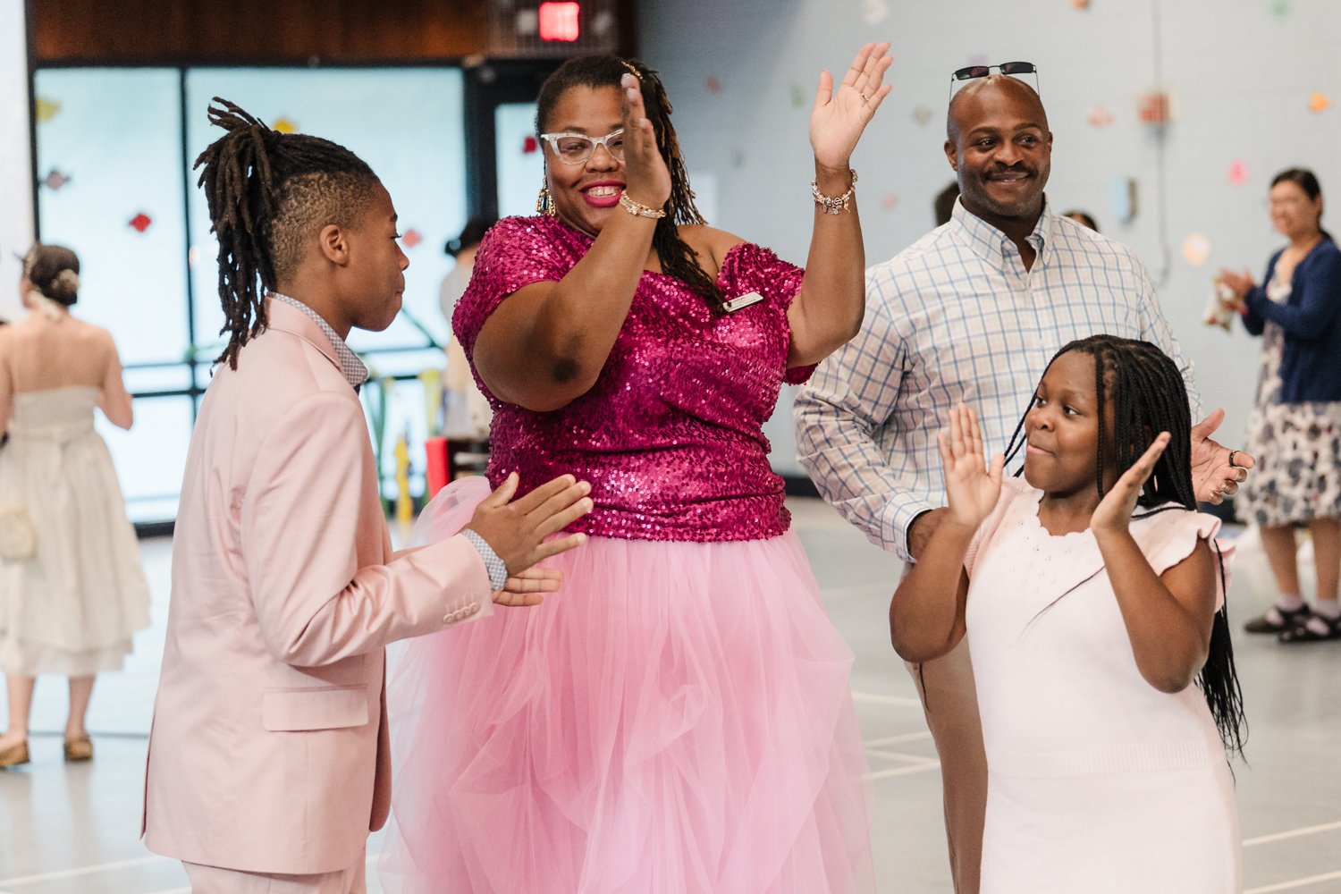 Two adults and two children enjoying music