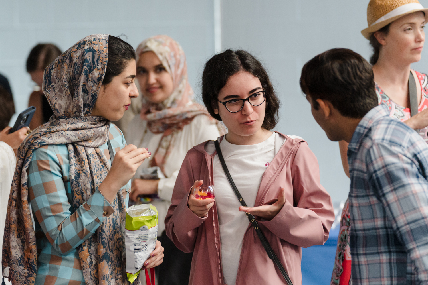 A group of people talking and eating snacks