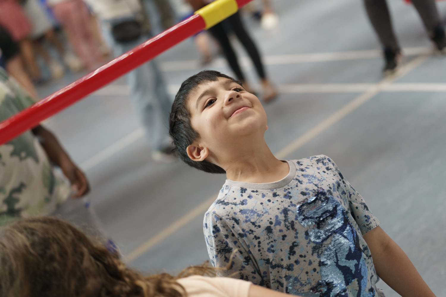 A smiling child ready to limbo