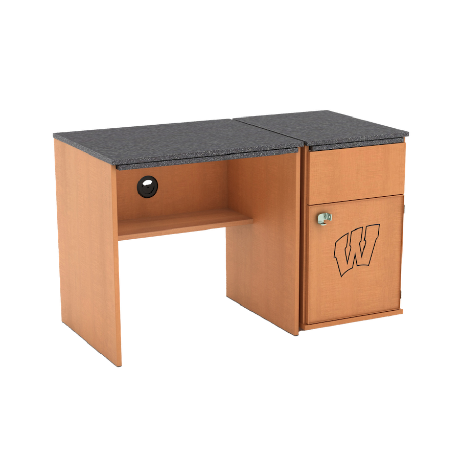 A medium-colored wood desk with a dark gray top and an attached pedestal with a drawer, a lockable cabinet, and the Wisconsin