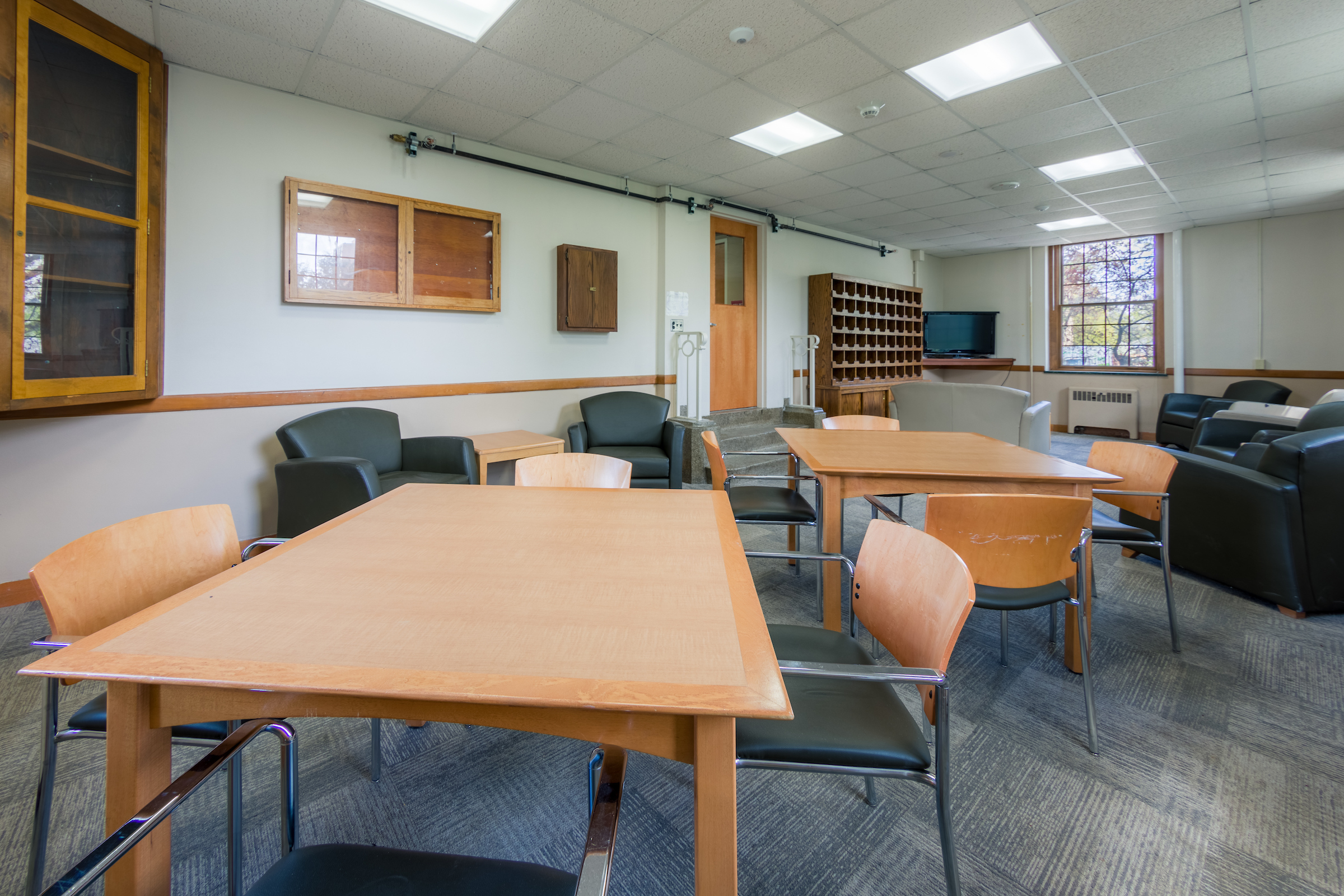 Tables and chairs in a lounge in Humphrey Residence Hall
