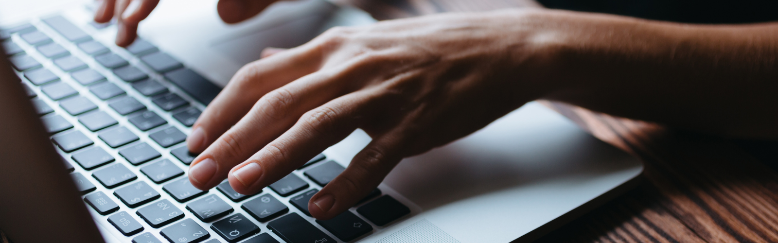 Person typing on keyboard up close