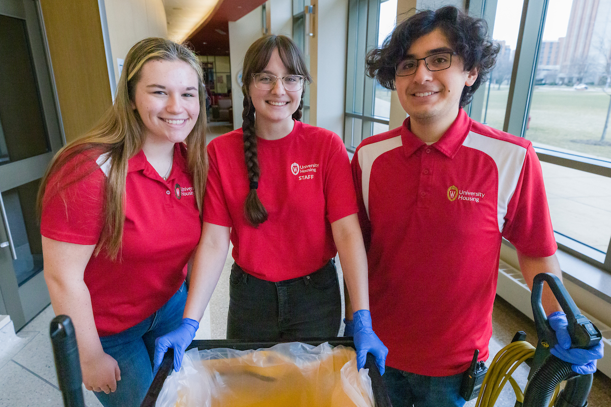 Three student custodians posing for a group photo