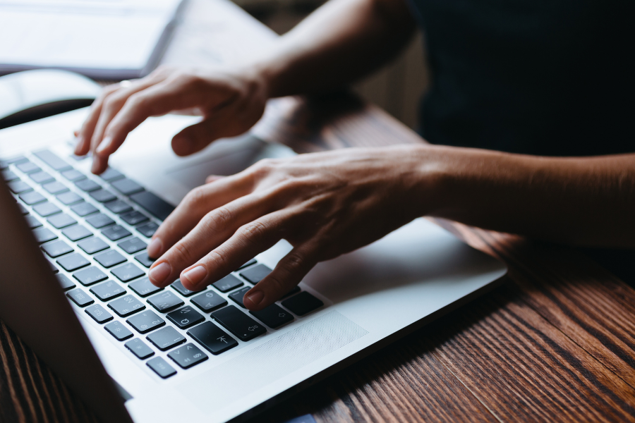 hands and fingers typing on a computer keyboard