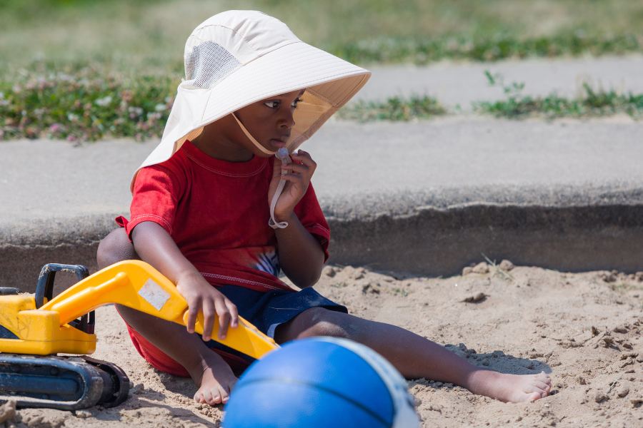Child playing in the sandbox at University Aprartments.