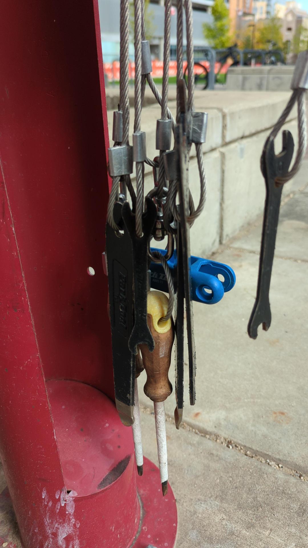 Tools attached to a bicycle repair statioin