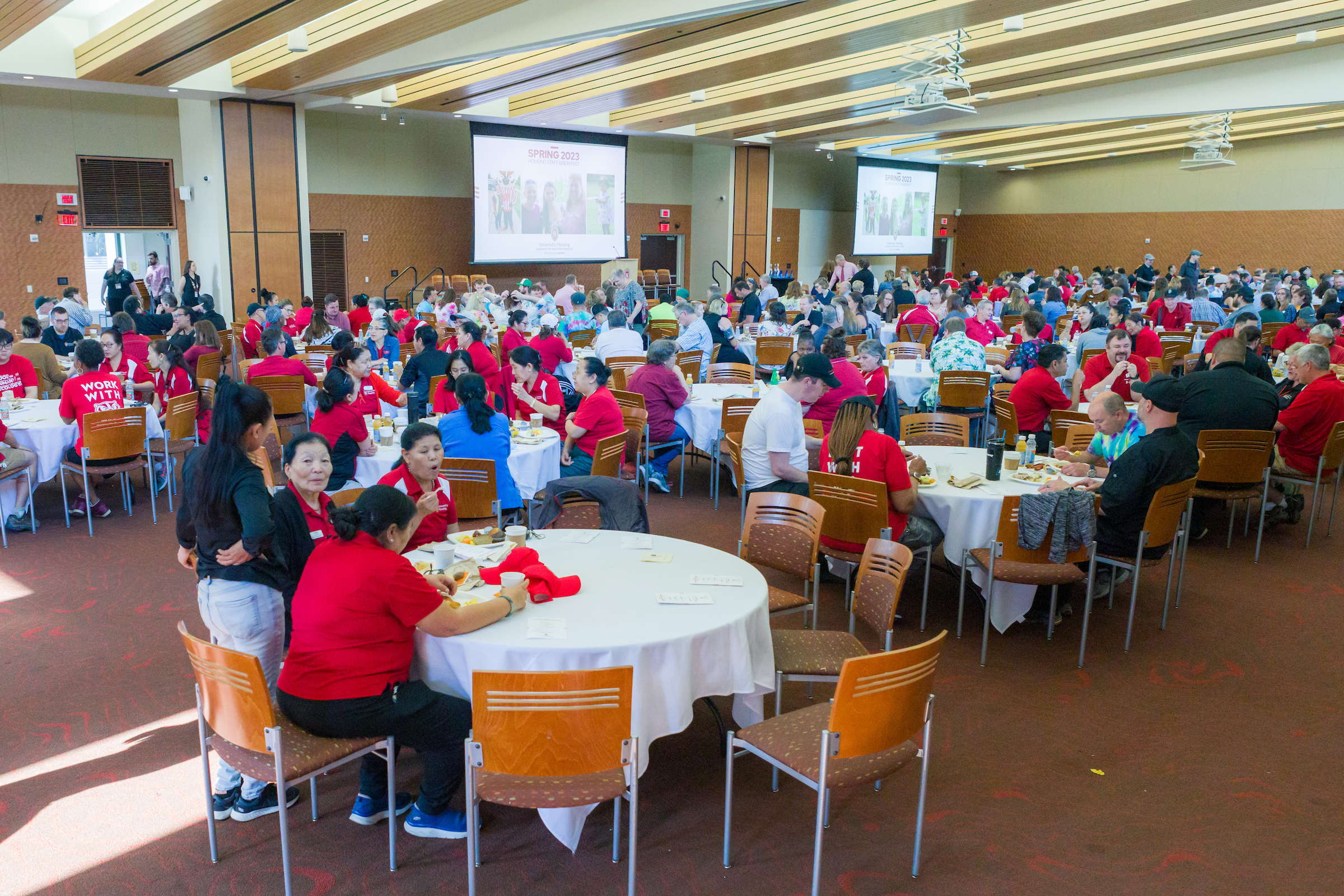 Staff sitting at tables at the annual Housing Breakfast