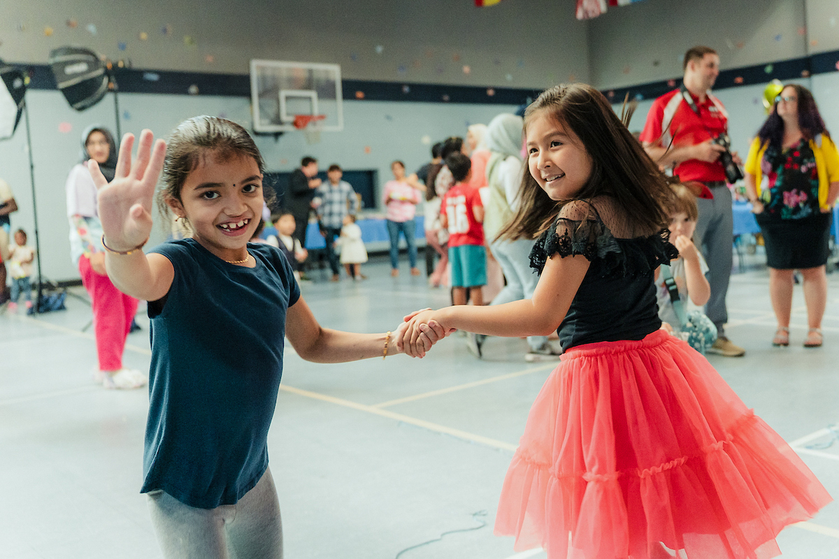Two children dancing together at the UA Family Prom