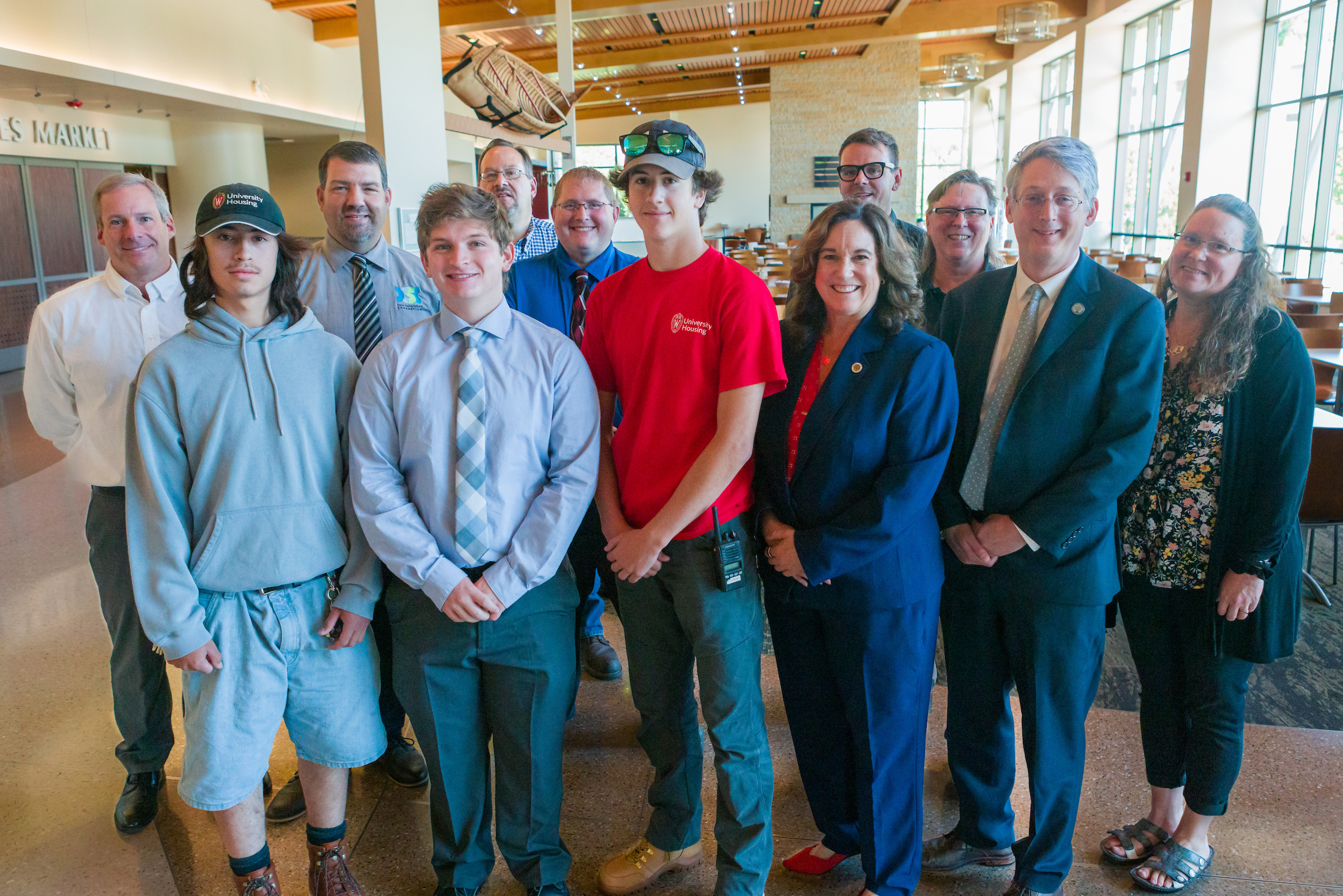 Department of Education and University Housing staff posing for a group photo at Four Lakes Market