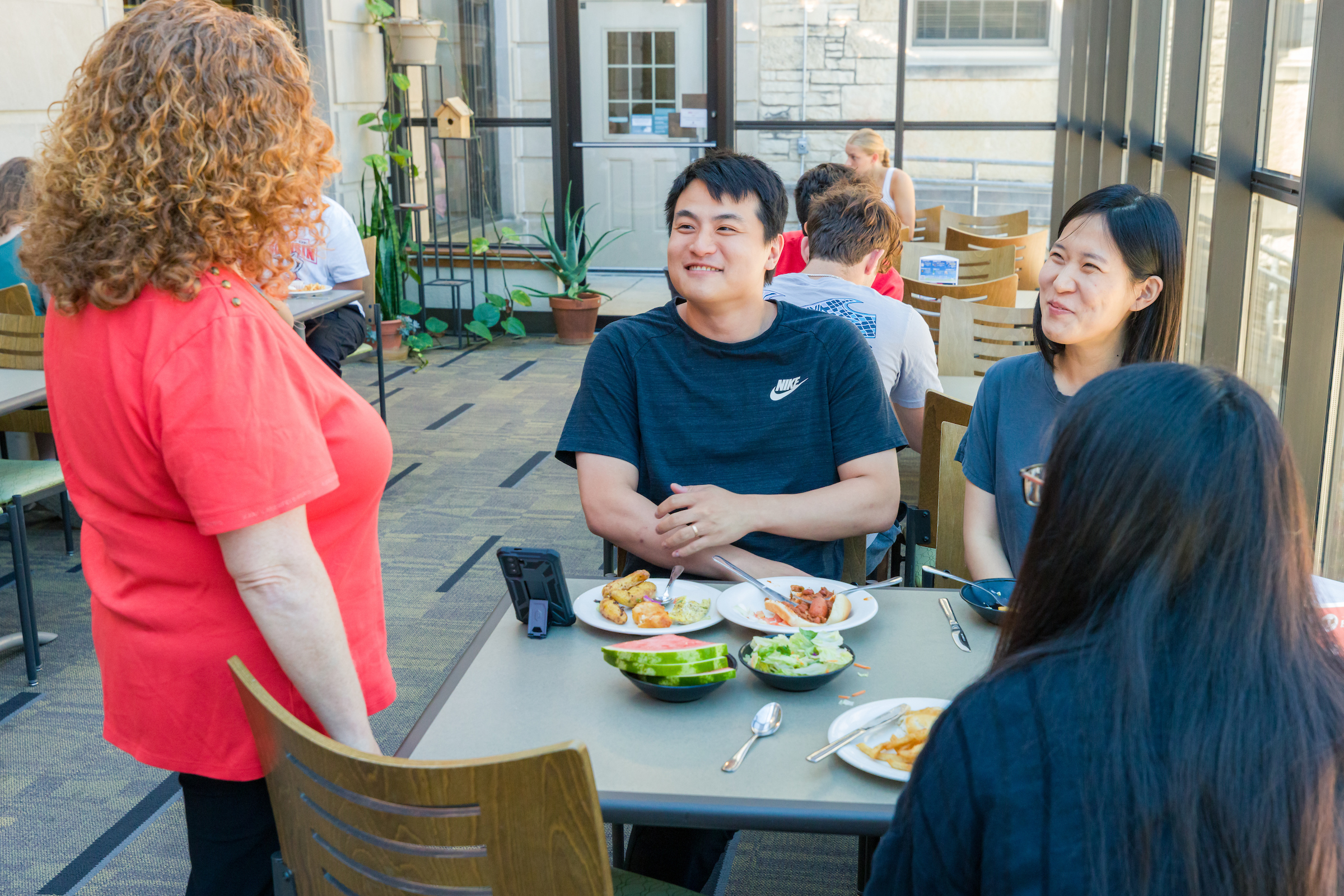 Chancellor Mnookin talks with people eating at Liz's Market