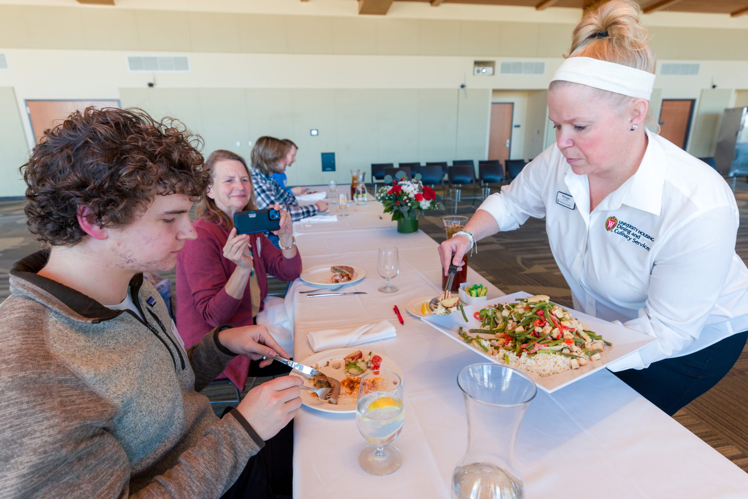A Dining staff member serves guests food