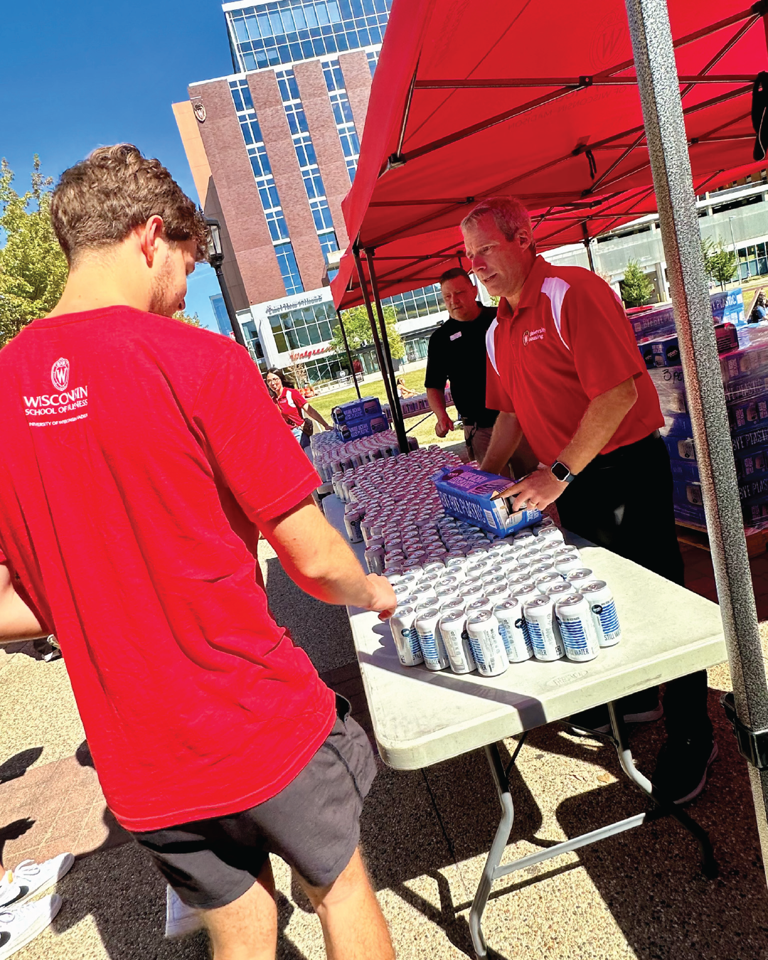 Housing Director Jeff handing out canned waters at convocation lunch