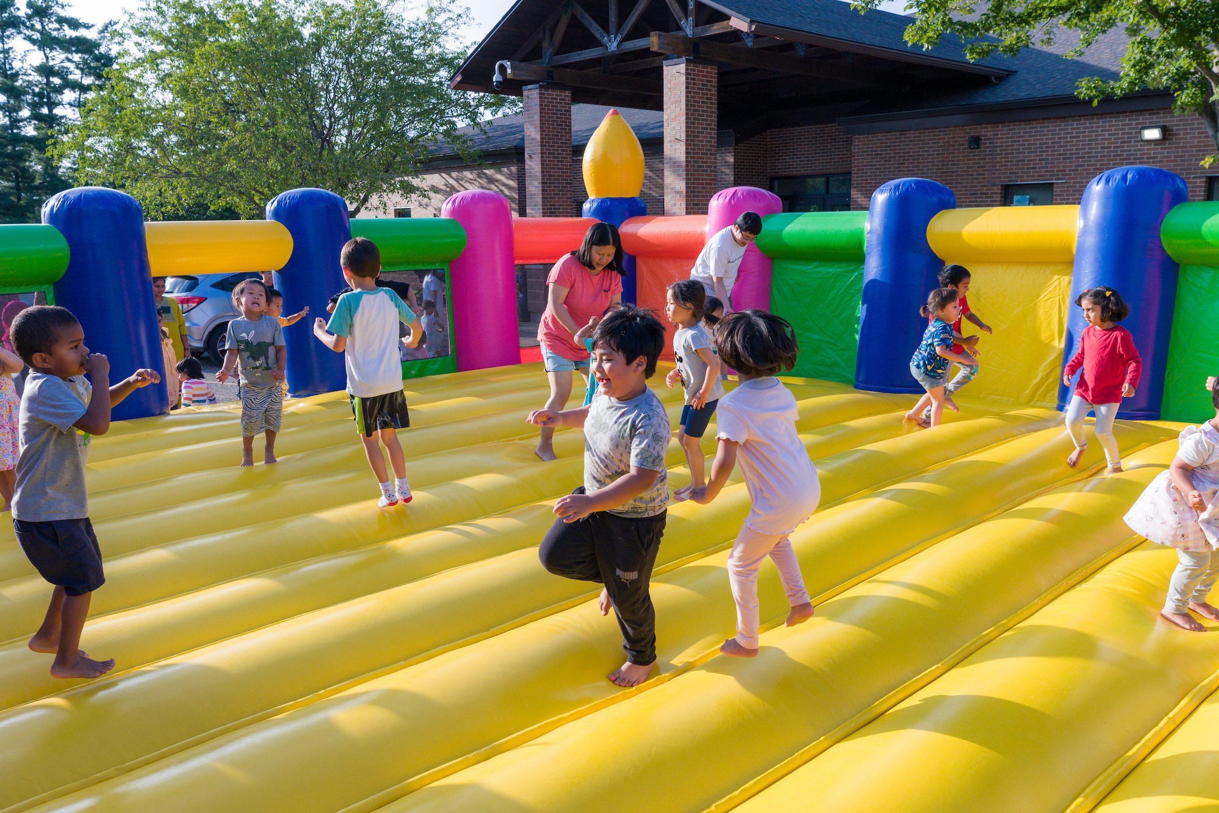 Many kids jumping in a bounce house
