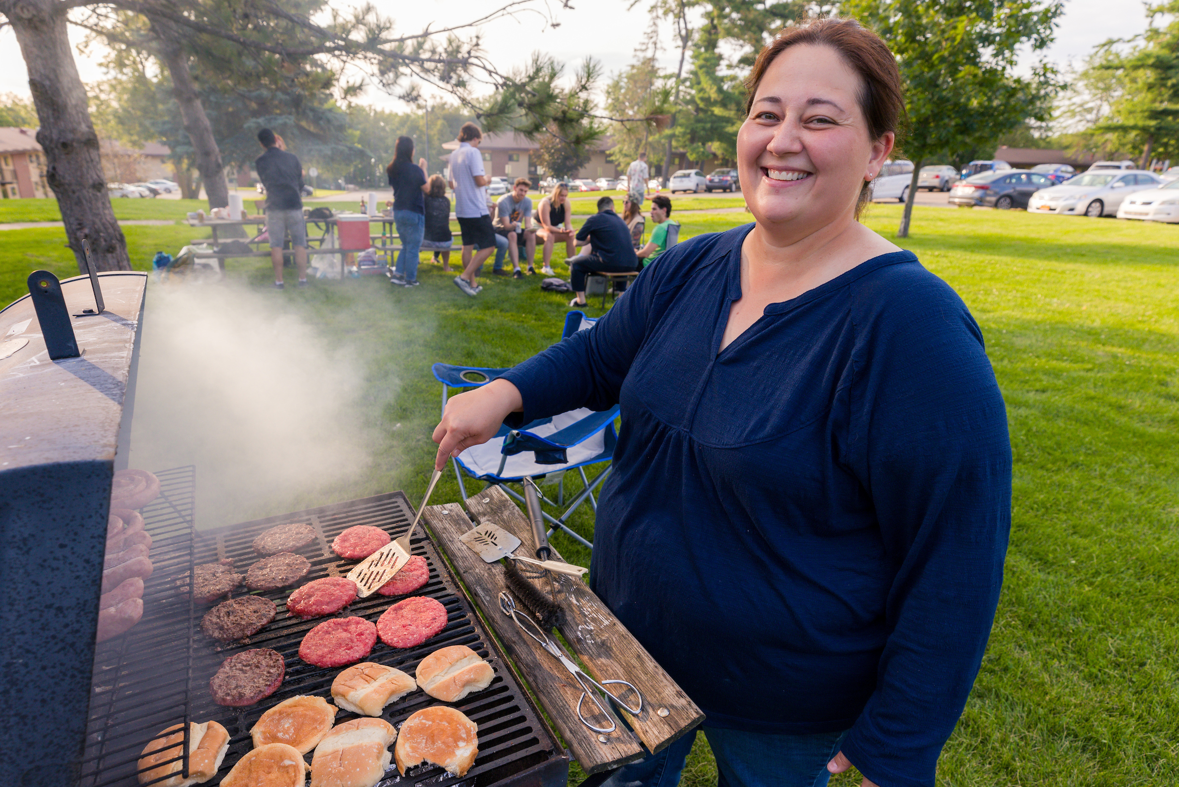 Women grilling outside burgers
