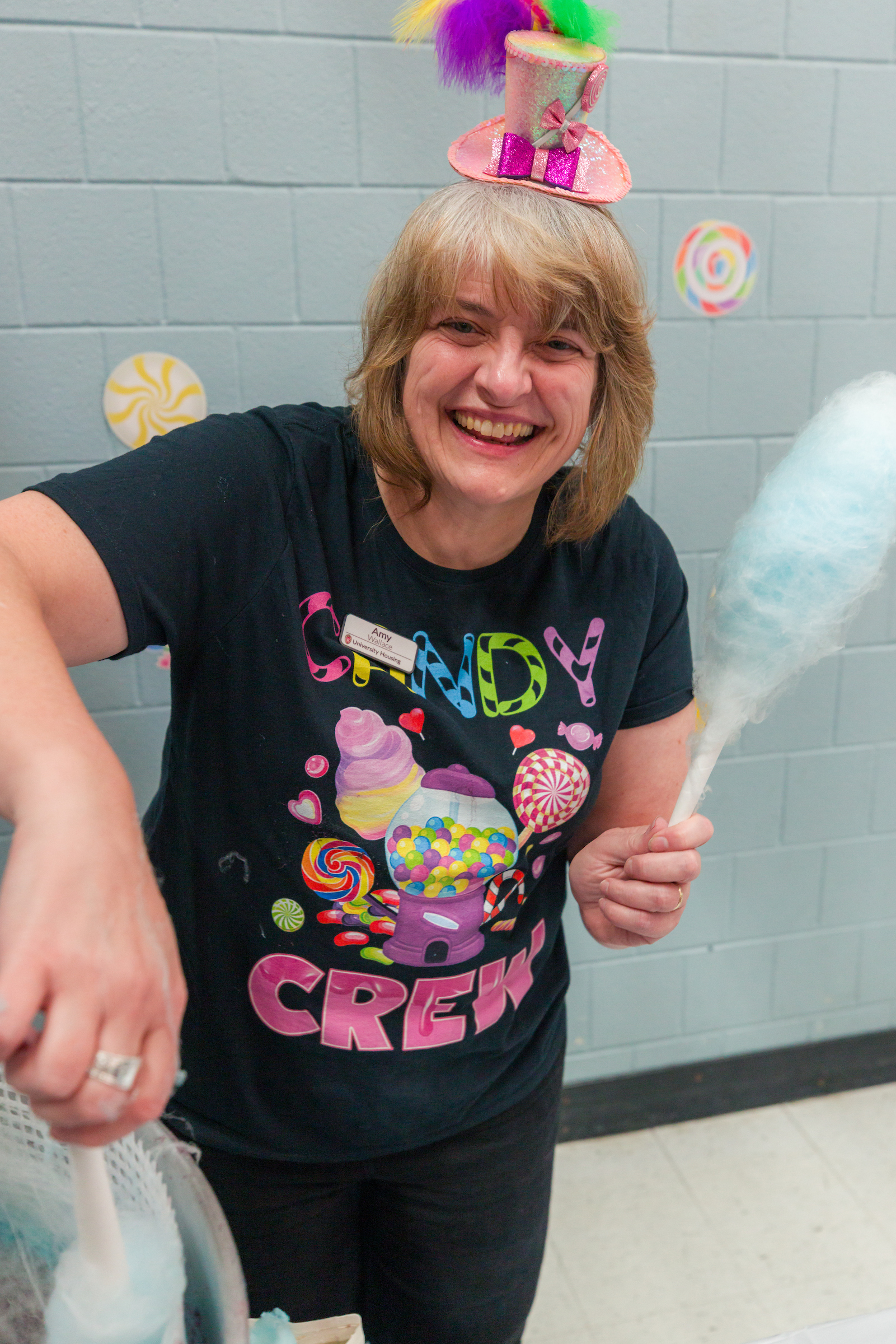 Women smiling at the camera while making cotton candy